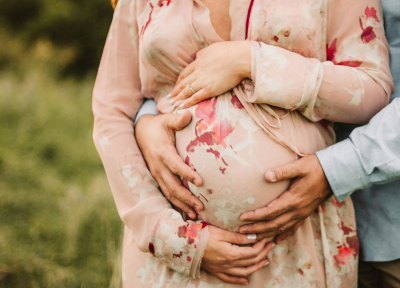 A woman holding her pregnant belly